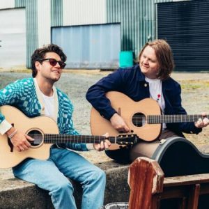 Photo of Niall Horan and Lewis Capaldi playing guitar and singing